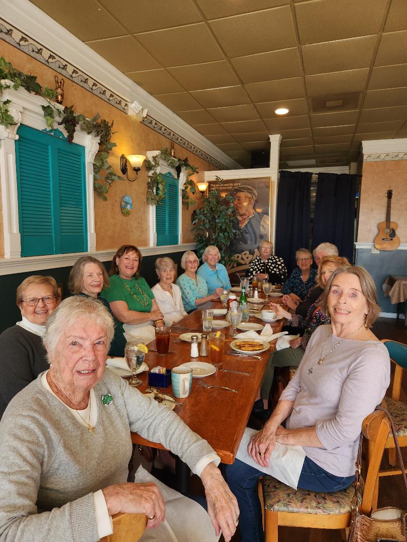 Group of women smiling and enjoying lunch